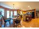 Charming dining area with a farmhouse-style table, wood floors, and an open view into the kitchen, creating a cozy atmosphere at 2221 W County Road 500 N, Danville, IN 46122