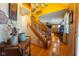 Inviting entryway features wood floors, staircase, and artistic wall decor with a glimpse into the bright, open living spaces at 2221 W County Road 500 N, Danville, IN 46122