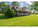 Beautiful brick home with a welcoming front porch, decorative bunting, and lush green lawn, perfect for outdoor enjoyment at 2221 W County Road 500 N, Danville, IN 46122