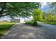 Exterior view of the property showcasing a large shed and well-maintained gravel driveway at 2221 W County Road 500 N, Danville, IN 46122