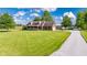 Lovely brick home with an inviting porch, patriotic bunting, attached garage, and a long driveway on a well-kept lawn at 2221 W County Road 500 N, Danville, IN 46122