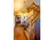 Bright foyer features hardwood floors, a beautiful wooden staircase, and a decorative chandelier at 2221 W County Road 500 N, Danville, IN 46122