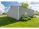 Corner view of tan garage/outbuilding with windows and lush landscaping at 2221 W County Road 500 N, Danville, IN 46122
