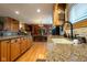 Close-up showcasing the kitchen's granite countertops, custom cabinets, and an inviting view into the dining area at 2221 W County Road 500 N, Danville, IN 46122