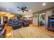 Open floor plan of the living room showcases hardwood floors, leather seating, and an open connection to the kitchen area at 2221 W County Road 500 N, Danville, IN 46122