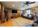 Cozy living room with hardwood floors, a comfortable leather sofa, a ceiling fan, and decorative furnishings at 2221 W County Road 500 N, Danville, IN 46122