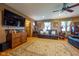 Comfortable living room with hardwood floors, leather seating, and a large TV, perfect for relaxing and entertaining at 2221 W County Road 500 N, Danville, IN 46122