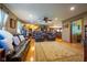 Bright living room features hardwood floors, comfortable leather furniture, and an open layout connecting to the kitchen at 2221 W County Road 500 N, Danville, IN 46122