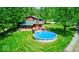 Beautiful backyard featuring a pool, deck, and charming red-roofed home at 2240 Bill Smith Rd, Martinsville, IN 46151