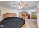 Large bedroom featuring a large bed, ceiling fan, doorway, and a wood paneled sauna at 2240 Bill Smith Rd, Martinsville, IN 46151