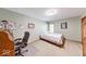 This bedroom features neutral walls, carpet, and an organized workspace with a desk and chair at 2240 Bill Smith Rd, Martinsville, IN 46151