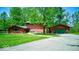 Charming home features a detached garage, well-maintained lawn, mature trees, and inviting curb appeal at 2240 Bill Smith Rd, Martinsville, IN 46151