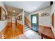 Inviting hallway with wood floors, wood paneled walls, and natural light streaming through the front door at 2240 Bill Smith Rd, Martinsville, IN 46151