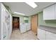 Functional laundry area with a washer, dryer, white cabinets, and a door at 2240 Bill Smith Rd, Martinsville, IN 46151