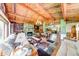 Open living room features exposed wood beams, wood paneling, stone fireplace, and hardwood floors at 2240 Bill Smith Rd, Martinsville, IN 46151