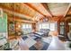 Open living room features exposed wood beams, wood paneling, and hardwood floors at 2240 Bill Smith Rd, Martinsville, IN 46151