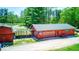 Spacious red outbuilding with a garage door offers ample storage and workspace for your hobbies and projects at 2240 Bill Smith Rd, Martinsville, IN 46151
