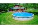 Enjoy this above ground pool, perfect for cooling off on a hot day, in the backyard of this red home at 2240 Bill Smith Rd, Martinsville, IN 46151