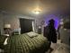 Cozy bedroom featuring warm lighting, decorative wall hangings, and comfortable bedding at 2710 Fairview St, Anderson, IN 46011
