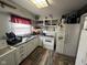Functional kitchen featuring white appliances and laminate flooring at 2710 Fairview St, Anderson, IN 46011