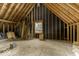 Unfinished attic space with exposed beams and a window, presenting potential for customization at 3134 W Hickory Woods Dr, Greenfield, IN 46140