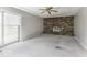 Spacious living room with sliding doors to the backyard and a cozy brick fireplace at 3134 W Hickory Woods Dr, Greenfield, IN 46140