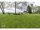 Spacious green lawn with outbuildings and mature trees at 3134 W Hickory Woods Dr, Greenfield, IN 46140