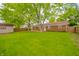 Large backyard features a brick house, shed, privacy fence, green lawn and a wooden deck at 331 W 5Th St, Lapel, IN 46051