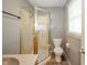 Bathroom featuring a glass shower enclosure, toilet, and tiled flooring with a window for natural light at 331 W 5Th St, Lapel, IN 46051