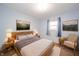 Cozy bedroom with light blue walls, wood furniture, and decorative artwork for a comfortable and stylish living space at 331 W 5Th St, Lapel, IN 46051