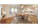 Sunlit dining area with a wooden table, six chairs, and a view of the adjacent kitchen at 331 W 5Th St, Lapel, IN 46051