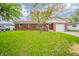Charming brick home featuring a well-manicured lawn and an attached one car garage at 331 W 5Th St, Lapel, IN 46051