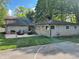 Backyard of home featuring stone and siding, grill, lawnmower, and a sports court at 3401 W Kessler Blvd N Dr, Indianapolis, IN 46222