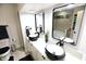 Modern bathroom features a double vanity, black fixtures, and a separate tub at 3401 W Kessler Blvd N Dr, Indianapolis, IN 46222