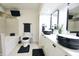 Modern bathroom features a double vanity, black fixtures, and a separate tub at 3401 W Kessler Blvd N Dr, Indianapolis, IN 46222