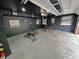 Finished garage includes dart board, painted walls and ceiling, and overhead lighting at 3401 W Kessler Blvd N Dr, Indianapolis, IN 46222