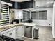 Spacious eat-in kitchen with stainless steel appliances, granite countertops, and wood-look tile floors at 3401 W Kessler Blvd N Dr, Indianapolis, IN 46222