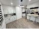 Spacious kitchen featuring white cabinets, stainless steel appliances, granite countertops, and seating at 3401 W Kessler Blvd N Dr, Indianapolis, IN 46222