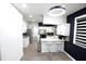 Open kitchen design with granite counters, breakfast bar, stainless appliances, and wood-look tile floors at 3401 W Kessler Blvd N Dr, Indianapolis, IN 46222