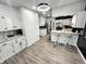 Modern kitchen featuring white cabinets, a breakfast bar, and updated lighting, creating a welcoming space at 3401 W Kessler Blvd N Dr, Indianapolis, IN 46222