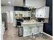 Bright eat-in kitchen with granite counters, white cabinets, stainless steel appliances, and modern tile backsplash at 3401 W Kessler Blvd N Dr, Indianapolis, IN 46222