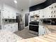 Well-equipped kitchen featuring modern appliances, white cabinetry, and granite countertops at 3401 W Kessler Blvd N Dr, Indianapolis, IN 46222