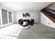 Finished basement living room with fireplace, modern decor, dark sofa, and hardwood floors at 3401 W Kessler Blvd N Dr, Indianapolis, IN 46222