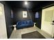 Finished room includes a blue couch, dark walls and light ceiling, and interior lighting at 3401 W Kessler Blvd N Dr, Indianapolis, IN 46222