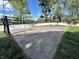Backyard basketball court with white fence and mature trees along the perimeter of the property at 3401 W Kessler Blvd N Dr, Indianapolis, IN 46222