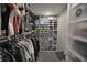 Organized walk-in closet with custom shelving for shoes and hanging space for clothes at 3401 W Kessler Blvd N Dr, Indianapolis, IN 46222