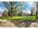 Expansive backyard with mature trees, green grass, and potential for outdoor activities at 3609 N Keystone Ave, Indianapolis, IN 46218