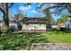 Well-manicured backyard with lush lawn, mature trees, and a view of neighboring homes at 3609 N Keystone Ave, Indianapolis, IN 46218
