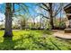 Lush backyard with mature trees providing ample shade and a view of the surrounding neighborhood at 3609 N Keystone Ave, Indianapolis, IN 46218