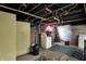 Unfinished basement featuring exposed beams, concrete walls, and a laundry area with washer and dryer at 3609 N Keystone Ave, Indianapolis, IN 46218